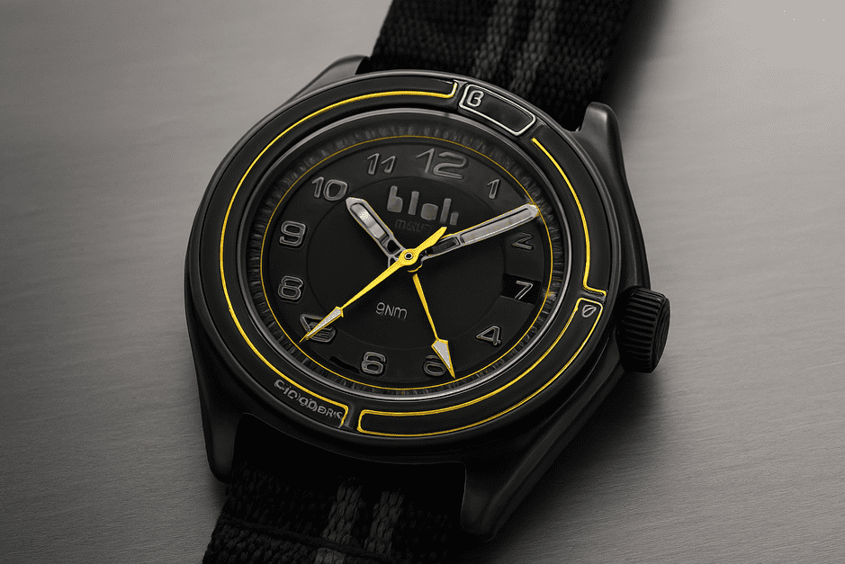 Blok 38 Black GMT watch with 38mm case, steel core, sapphire crystal, and dual-time display with two nylon straps.