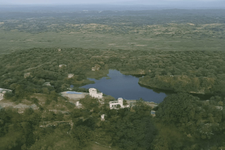 A rustic private cottage with a rock-carved pool nestled in the natural landscape of Brij Lakshman Sagar, a boutique retreat in Rajasthan.