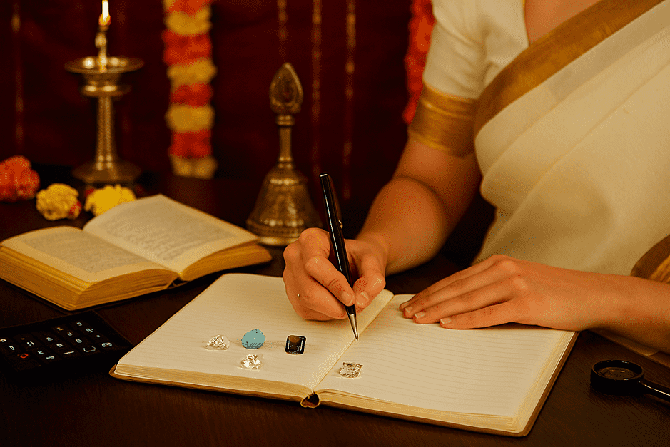 Gemology notebook practice with a gemologist writing stone details—color, clarity, and luster.
