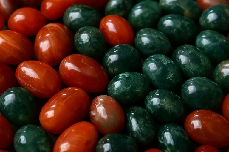 A pile of polished red and orange Agates of Cambay beads.