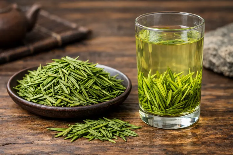 A glass of Bamboo Leaf Green Tea with buds standing vertically in hot water.