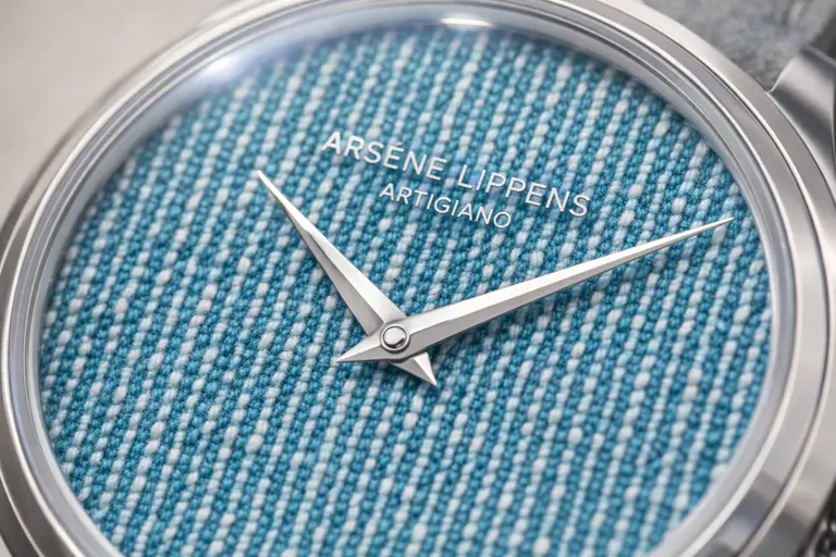 A close-up of the turquoise Portofino dial of the Arsène Lippens Artigiano watch.