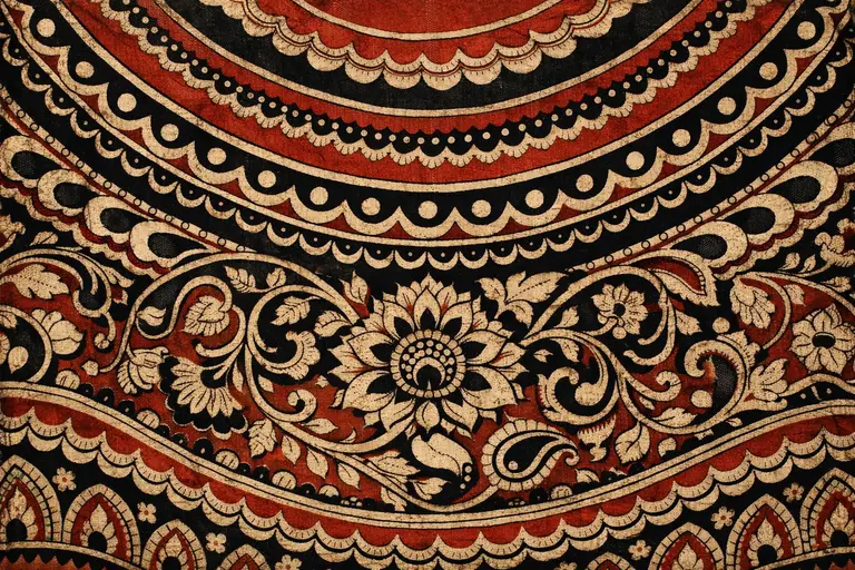 A close-up of Karuppur Kalamkari art featuring intricate hand-painted vine and floral motifs.